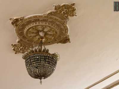 Qui spiccano i lampadari in ottone e cristallo che pendono da rosoni in stile liberty